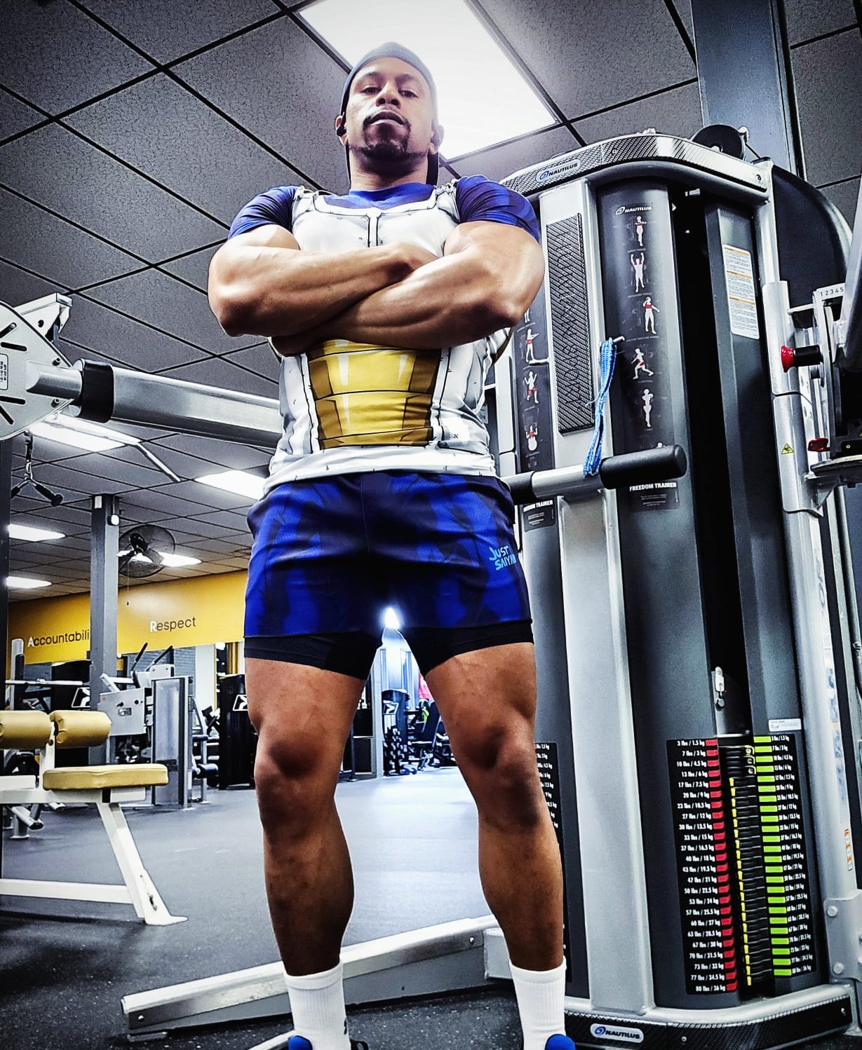 Chrys, founder of NoLimitSquad, arms crossed in Saiyan armor training gear